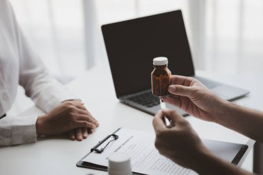 Doctors are giving advice on treatment to patients in hospital examination rooms, treating diseases from specialists and providing targeted treatment. Concepts of medical treatment and specialists.