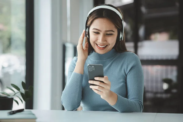 stock image Woman playing with mobile phone, she is surfing the internet on her smartphone and socializing with her friends. and acquaintances on online platforms. Concept of social applications on mobile phones.