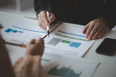 Atmosphere of a startup company meeting, business people are meeting together to summarize and plan investment finances, they are the founders of the company. Business administration concept.