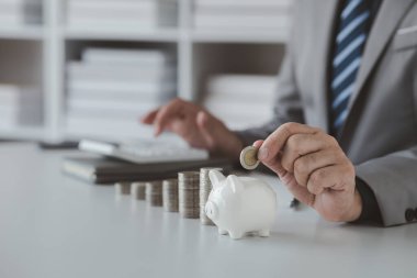 Person with pile of coins and piggy bank, money saving concept for future use and financial stability, salary management, personal finance, investment savings.