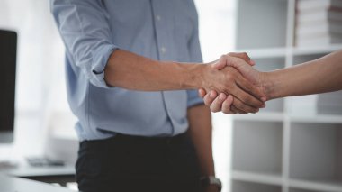 Business investor group holding hands, Two businessmen are agreeing on business together and shaking hands after a successful negotiation. Handshaking is a Western greeting or congratulation.