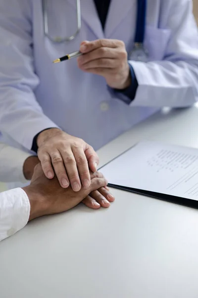 stock image The doctor and the patient are discussing the details of the treatment, the results of the physical examination of the patient. Annual physical examination concept.