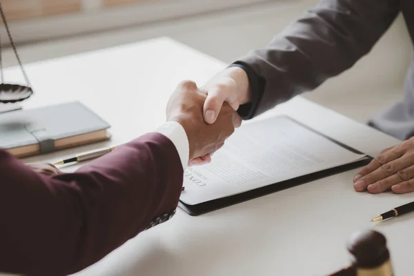 stock image Lawyer and client shake hands, after winning a lawsuit where a lawyer hired by a client in a fraud case and proceeding in a fair and correct manner, the client wins the case. Fraud litigation concept.