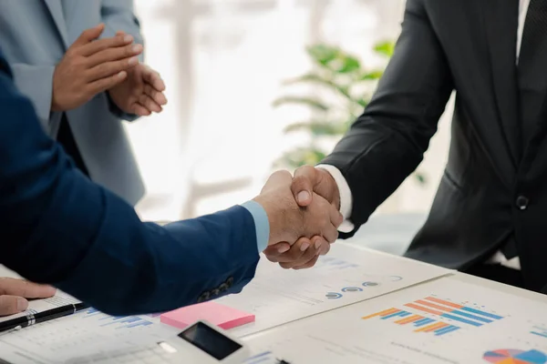 stock image Two businessmen holding hands, Two businessmen are agreeing on business together and shaking hands after a successful negotiation. Handshaking is a Western greeting or congratulation.