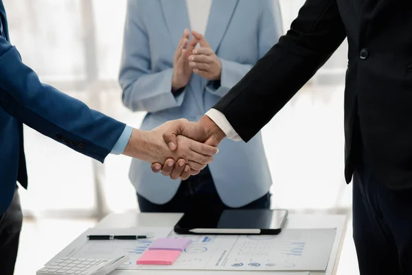 stock image Two businessmen holding hands, Two businessmen are agreeing on business together and shaking hands after a successful negotiation. Handshaking is a Western greeting or congratulation.