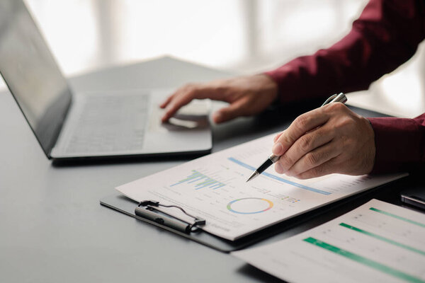 Business men are looking at the company's financial documents to analyze problems and find solutions before bringing the information to a meeting with a partner. Financial concept.