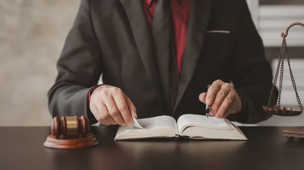 Stock image Lawyers read legal books defend their clients' cases, the lawyer concept assumes that the defendant defends the client in order to win the case or gain the greatest benefit in accordance with the law.