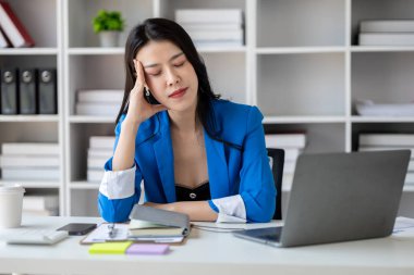 Uzun çalışma saatleri ve iş sorunları yüzünden stres altında olan güzel Asyalı kadın, aşırı çalışma yüzünden ofis sendromu geçiren genç iş kadını, ağrıya ve baş ağrısına neden oluyor. Ofis sendromu kavramı.