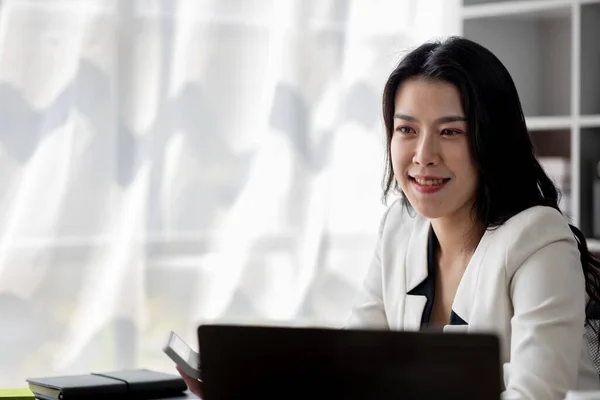 在公司办公室工作的年轻美丽的亚洲女人 在办公室工作的女商人 都在专心致力于创业企业的成长和现代化 她正在分析公司的市场和金融数据 — 图库照片