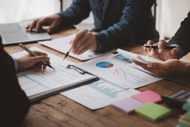 The sales department is having a monthly summary meeting to bring it to the department manager, they are verifying the correctness of the documents that are prepared before bringing in to the manager