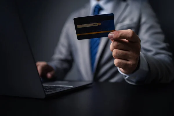 stock image Man in suit with credit card, businessman hold credit card, using credit card to pay for goods and services in store, online shopping on website and paying by credit card. Online shopping concept.