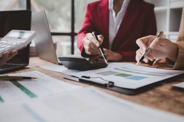The sales department is having a monthly summary meeting to bring it to the department manager, they are verifying the correctness of the documents that are prepared before bringing in to the manager.