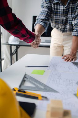 The home design architects are reviewing the house plan draft, the project commissioned by the client, and the custom design before delivery. Interior design and decoration ideas.