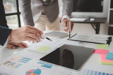 Atmosphere of a startup company meeting, business people are meeting together to summarize and plan investment finances, they are the founders of the company. Business administration concept.