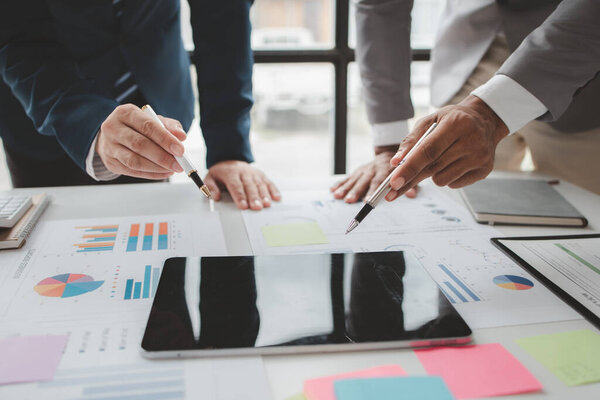 Atmosphere of a startup company meeting, business people are meeting together to summarize and plan investment finances, they are the founders of the company. Business administration concept.