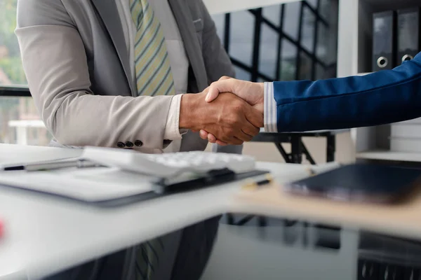 stock image Two business men shake hands, Two businessmen are agreeing on business together and shaking hands after a successful negotiation. Handshaking is a Western greeting or congratulation.