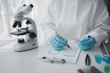 Lab practitioner working on chemical research for chemical reactions, does a chemical experiment and examines a patient's blood sample. Medicine and research concept.