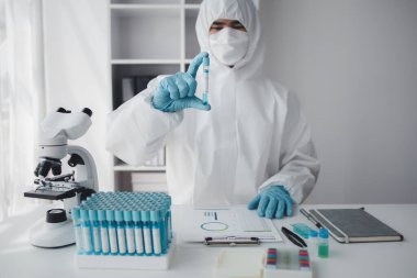 Lab practitioner working on chemical research for chemical reactions, does a chemical experiment and examines a patient's blood sample. Medicine and research concept.