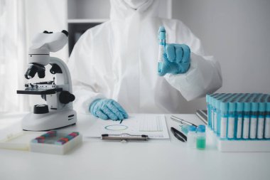 Lab practitioner working on chemical research for chemical reactions, does a chemical experiment and examines a patient's blood sample. Medicine and research concept.
