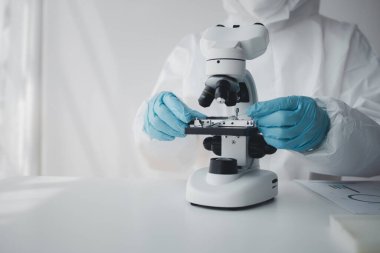 Lab practitioner working on chemical research for chemical reactions, does a chemical experiment and examines a patient's blood sample. Medicine and research concept.