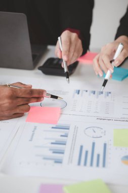 Atmosphere of a startup company meeting, business people are meeting together to summarize and plan investment finances, they are the founders of the company. Business administration concept.