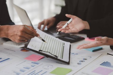 Atmosphere of a startup company meeting, business people are meeting together to summarize and plan investment finances, they are the founders of the company. Business administration concept.