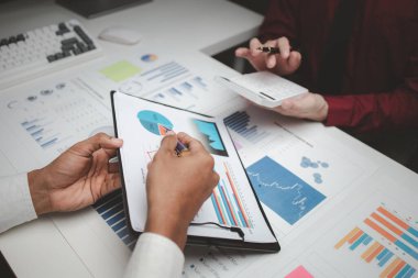 Atmosphere of a startup company meeting, business people are meeting together to summarize and plan investment finances, they are the founders of the company. Business administration concept.
