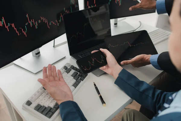 Two stock investors with stock market graph screen, stock fluctuation analysis, business man trading stocks for profit, stock market fluctuation graph screen, profit trading analysis.