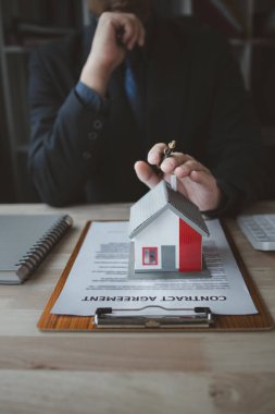 Ev satış temsilcileri ve satış temsilcileri projedeki evleri görmek isteyen müşterilere projede konut detaylarını tavsiye ediyorlar. Gayrimenkul ticareti.