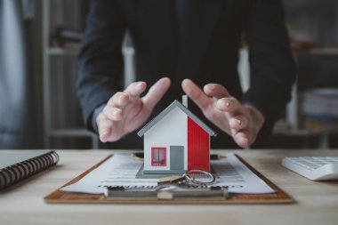 Ev satış temsilcileri ve satış temsilcileri projedeki evleri görmek isteyen müşterilere projede konut detaylarını tavsiye ediyorlar. Gayrimenkul ticareti.