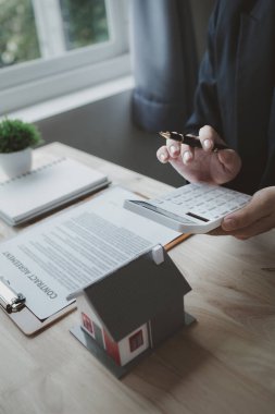Ev satış temsilcileri ve satış temsilcileri projedeki evleri görmek isteyen müşterilere projede konut detaylarını tavsiye ediyorlar. Gayrimenkul ticareti.