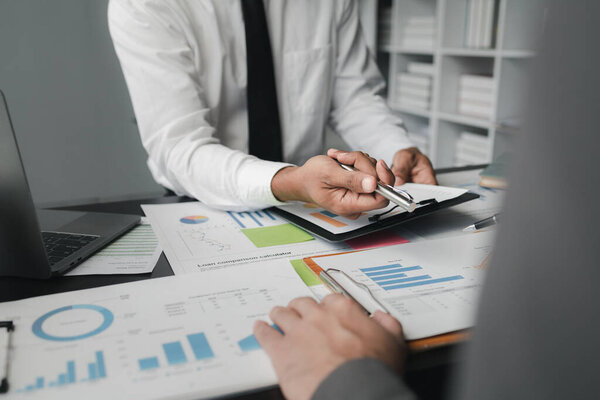 In a meeting between the finance and marketing departments to discuss work plans, two startup employees are brainstorming ideas for a profitable operating plan. Planning meeting concept.