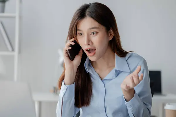 Asian woman talking on the phone, business woman talking on the phone with partner discussing joint venture company, talking on the phone. Communication concept.