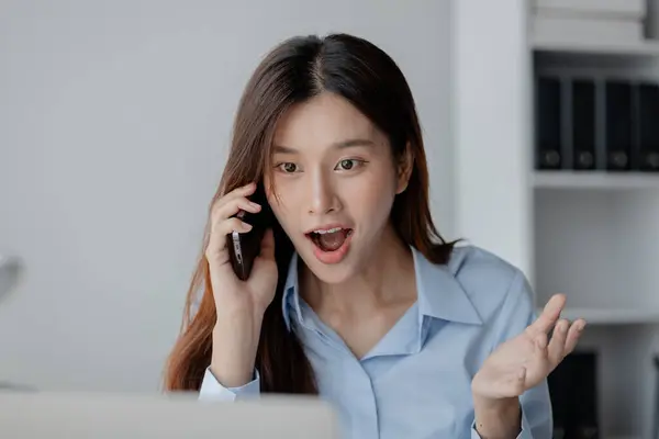 Asian woman talking on the phone, business woman talking on the phone with partner discussing joint venture company, talking on the phone. Communication concept.