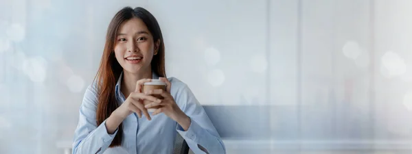 Asian woman sitting in startup company office, businesswoman, executive and investor in business and stocks, management of young people, new concept. Start-up company management concepts.
