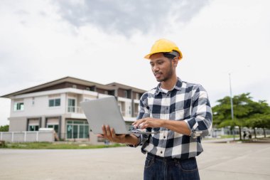 The home design architects are reviewing the house plan draft, the project commissioned by the client, and the custom design before delivery. Interior design and decoration ideas.