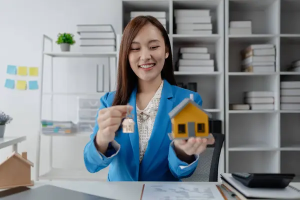 Housing project sales staff make sales presentations of various types of houses. to customers who visit and explain trading details. Home and real estate salesperson concept.