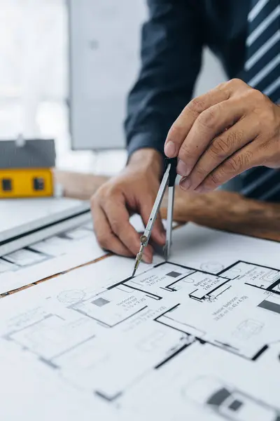 Architects sketch and edit real estate building plans, design buildings according to standards and plan structures, draw professional floor plans. Real estate design and construction concepts.