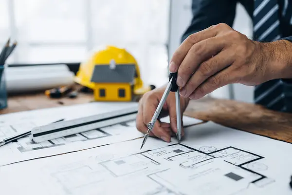 Architects sketch and edit real estate building plans, design buildings according to standards and plan structures, draw professional floor plans. Real estate design and construction concepts.