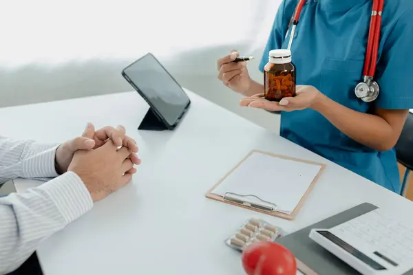 Doctors are giving advice on treatment to patients in hospital examination rooms, treating diseases from specialists and providing targeted treatment. Concepts of medical treatment and specialists.