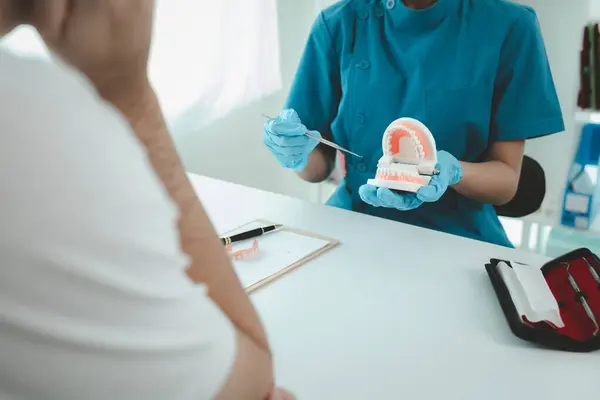 Man undergoes a dental checkup with professional dentist at dental clinic, undergoes a dental checkup with a professional dentist and receives oral care advice. Concept of receiving dental treatment.