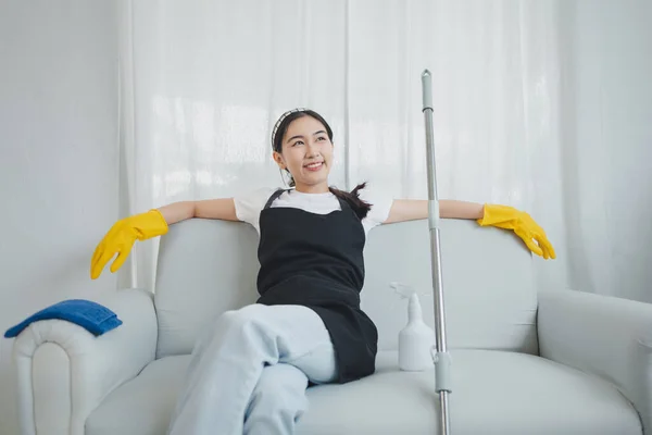 Clean the furniture in the house, Sit and rest after cleaning, Wear the uniform of the cleaning staff for neatness, Wear rubber gloves when working with cleaning chemicals, cleaning idea.