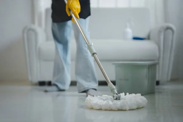 Cleaning staff mopping floors at home Wear an apron and rubber gloves to protect against cleaning chemicals. Use a mop to clean the floor. keep clean inside the house to prevent germs cleaning ideas.