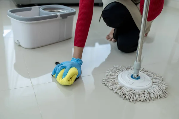 Clean the floor with a mop, Clean the floor in the living room, Clean the rooms inside the apartment for hygiene, Use a towel to wipe the floor clean, cleaning idea.