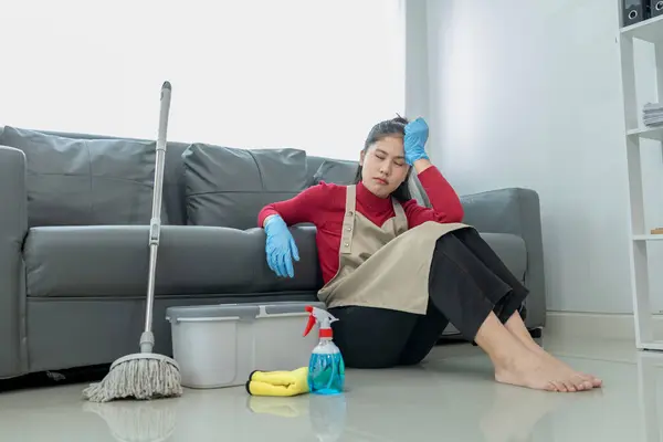 Sit and rest while doing housework, Feeling tired while mopping the floor, Wear an apron and rubber gloves to protect against cleaning chemicals, cleaning idea.