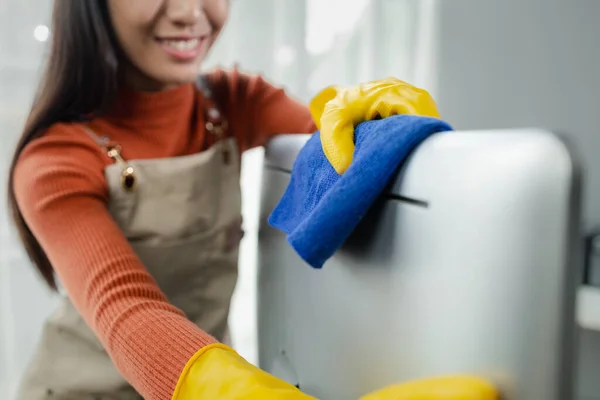Janitor cleaning the office, Clean the monitor with a rag, wear gloves and wipe with a towel, Wear rubber gloves when working with cleaning chemicals, cleaning idea.