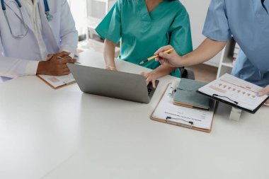 Bir grup doktor salgının sorununu çözmek için bir araya geldi, hastanede büyük bir ameliyat hakkında bir toplantı yapıldı, doktor hastanın belgelerini alıp ekiple görüştü..