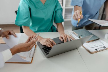 Bir grup doktor salgının sorununu çözmek için bir araya geldi, hastanede büyük bir ameliyat hakkında bir toplantı yapıldı, doktor hastanın belgelerini alıp ekiple görüştü..