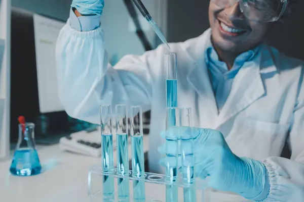 Chemist is chemically analyzing test tubes, Scientist is experimenting with chemicals in the laboratory, Chemist is separating compounds in test tubes with chemical reagents.