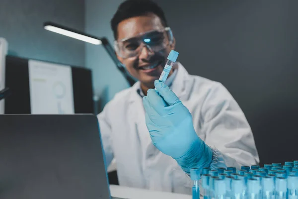 Chemist is chemically analyzing test tubes, Scientist is experimenting with chemicals in the laboratory, Chemist is separating compounds in test tubes with chemical reagents.